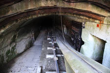 A tunnel with a train track
Description automatically generated with medium confidence
